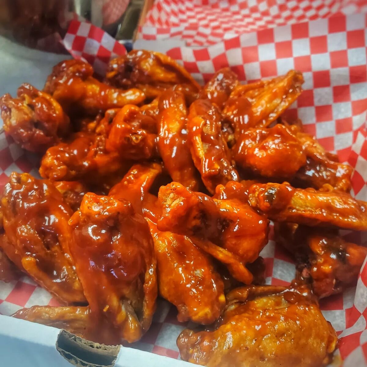 Chicken wings coated in glossy buffalo sauce